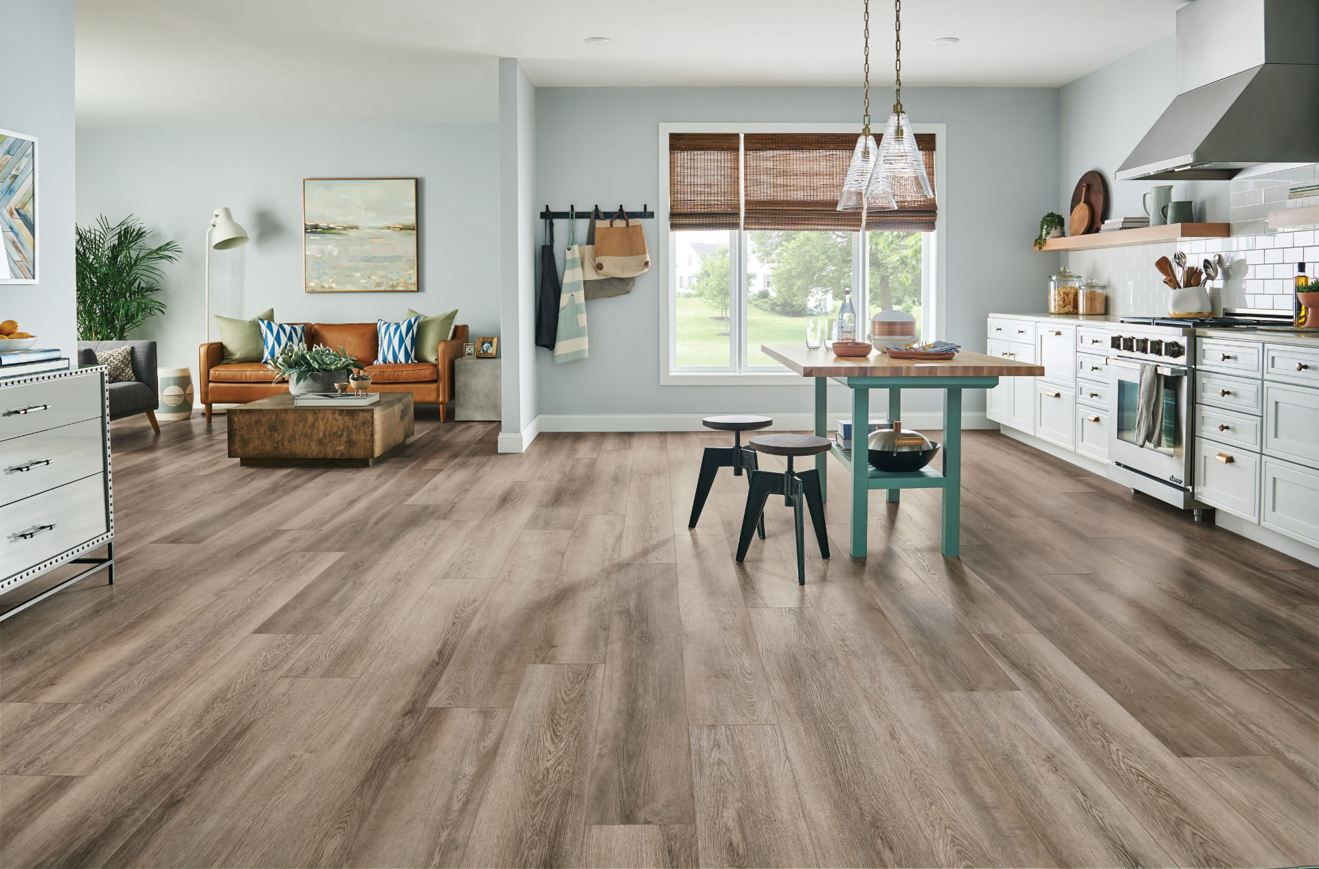 Open plan living and kitchen with wide plank wood flooring